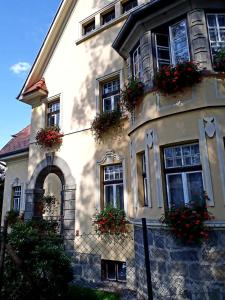 a house with flower boxes on the side of it at Penzion Romance in Vyšší Brod