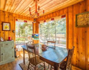 a dining room with a wooden table and chairs at Buckeye's Cabin in Leadville