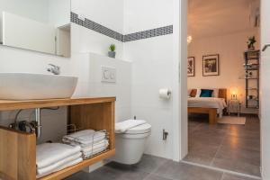 a bathroom with a sink and a toilet at Villa Olea, luxury retreat with nature blend in Novalja +36 photos
