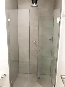 a shower with a glass door in a bathroom at KLEINN HOTEL BOGOTÁ in Bogotá