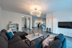 a living room with two couches and a table at Villa Olea, luxury retreat with nature blend in Novalja