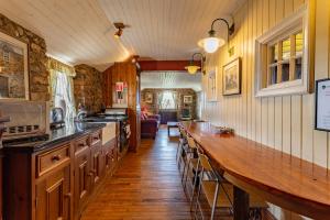 a kitchen with a long counter and a long table at Clenaghans in Moira
