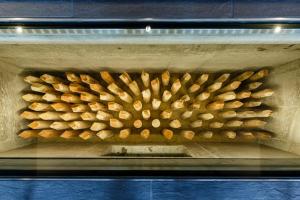 a stack of pine logs in an oven at Hotel Ninja Black in Kyoto