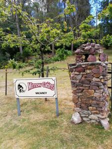 a sign for a museum with a stone wall at Minnow cabins Lower Beulah in Sheffield