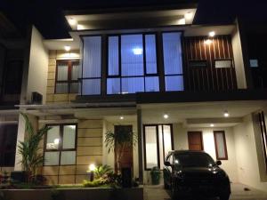 a car parked in front of a house at night at Fams Homestay by FH Stay in Yogyakarta