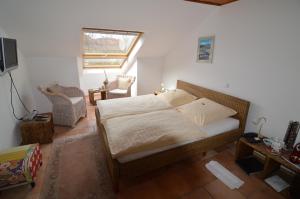 a bedroom with a bed and a window and a television at Landhotel Maarheide in Niederdürenbach