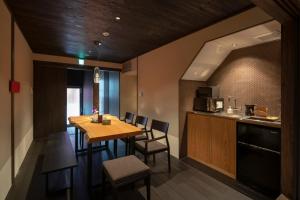 a kitchen and dining room with a table and chairs at Mimari Machiya House in Kanazawa