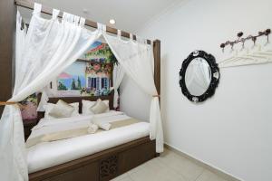 a bedroom with a bed and a mirror at Hotel de Art @ Section 19 in Shah Alam