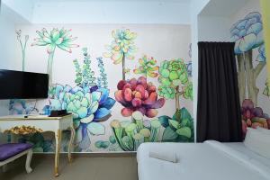 a room with a mural of flowers on the wall at Hotel de Art @ Section 19 in Shah Alam