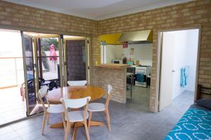 a kitchen and dining room with a table and chairs at Lancelin Lodge in Lancelin