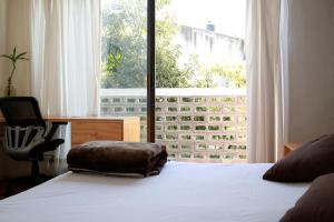 Tempat tidur dalam kamar di Coyoacan City Lofts