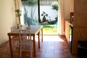 a dining room with a table and chairs and a window at Coyoacan City Lofts in Mexico City