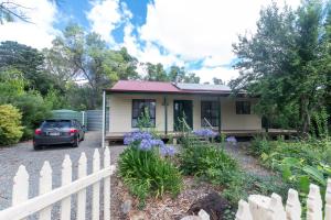 a small house with a car parked in front of it at Auburn Hideaway Clare Valley in Auburn