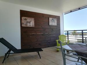 a room with a brick wall and a table and chairs at Appartement Meublé de Tourisme in Saint-Pierre