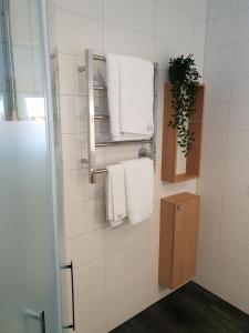a bathroom with white towels hanging on a wall at Kukkolaforsen Turist & Konferens in Kukkola