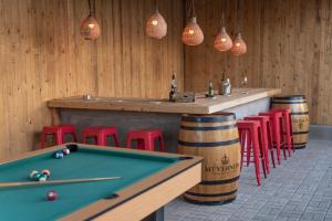 a bar with a pool table and some red stools at Route 40 in Hoedspruit
