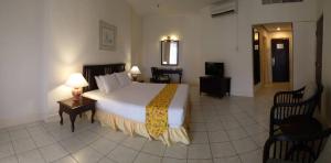 A bed or beds in a room at The Orient Star Resort Lumut