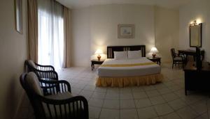 A bed or beds in a room at The Orient Star Resort Lumut