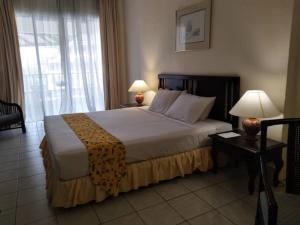A bed or beds in a room at The Orient Star Resort Lumut