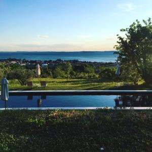 a swimming pool with a view of the water at Prati Palai in Bardolino