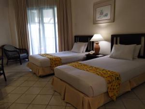 A bed or beds in a room at The Orient Star Resort Lumut