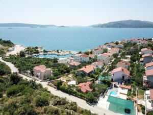 an aerial view of a residential neighborhood next to the water at Summer rental house "Kava" in Okrug Donji