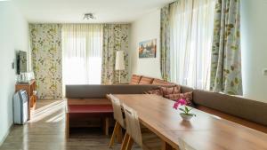 a living room with a table and a couch at Easyapartments Riverside in Salzburg