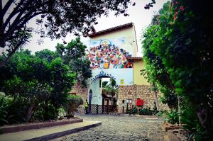 a building with a mural on the side of it at Porto Antigo Hotel BB in Santa Maria