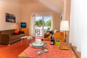 a living room with a couch and a table at Hotel Haus Seeblick in Nideggen