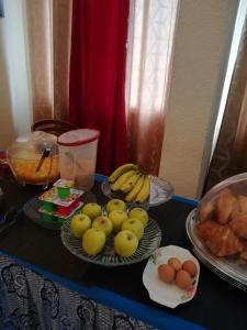 a table with a bunch of bananas and other fruits at Hotel Vivi Palace in Matadi