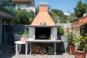 a outdoor pizza oven on a patio at Summer rental house "Kava" in Okrug Donji