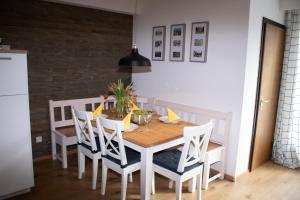 a dining room with a wooden table and chairs at Welcome in - Wohnung mit Dachterrasse direkt an der Piste in Winterberg