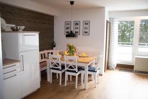a kitchen and dining room with a table and chairs at Welcome in - Wohnung mit Dachterrasse direkt an der Piste in Winterberg +97 photos