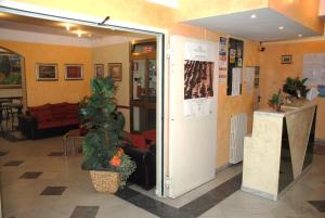 a lobby with an open door with a plant at Hotel Annunziata in Massa