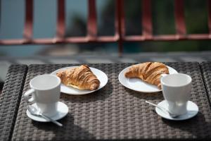 two plates of croissants and two cups on a table at Harmony in Amalfi