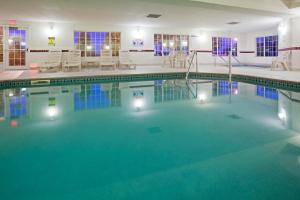 a large swimming pool with lights in a building at Country Inn & Suites by Radisson, Mankato Hotel and Conference Center, MN in Mankato