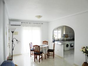 a kitchen and dining room with a table and chairs at Pancho Apartment Doña Pepa - C. Quesada in Rojales