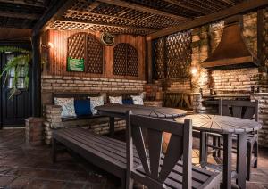 a patio with two tables and a bench and a stove at The Grand Gables in Nairobi