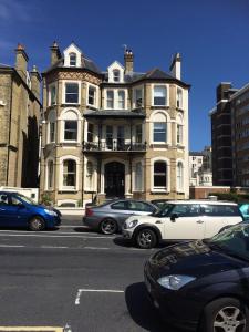 a group of cars parked in front of a building at Seaview Mansion Apartment - Central Hove with PARKING in Brighton & Hove +5 photos