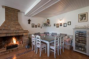 a dining room with a table and a fireplace at Penzion Stříbrný vítr in Horní Planá