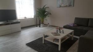 a living room with a couch and a coffee table at Fewo Am Marktplatz I in Eisenhüttenstadt