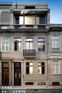 ein großes Backsteingebäude mit Fenstern und einem Balkon in der Unterkunft Casa do Conto - Arts & Residence in Porto