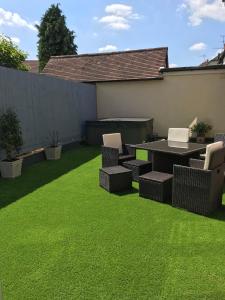 a backyard with a table and chairs and grass at Stratford House in Stratford-upon-Avon +2 photos