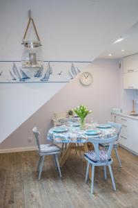 a dining room with a table and two chairs at Apart Harmony - Apartamenty Zatoka Pucka in Puck
