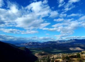 a view of a valley under a blue sky with clouds at Acropole Delphi City Hotel in Delphi