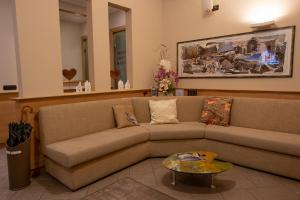 a living room with a couch and a table at Hotel Bernina in Tirano