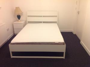 a bed in a small room with a white bed frame at WESTEND PROPERTY in Aberdeen