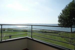 einen Balkon mit Blick auf das Wasser in der Unterkunft Ferienwohnung Leuchtturm 21 in Schausende