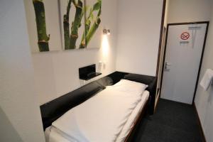 Postel nebo postele na pokoji v ubytování Hotel Bienvenue