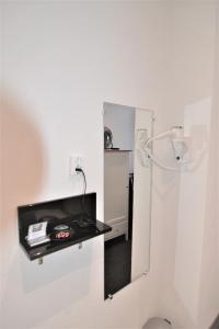 
a white wall with a white refrigerator next to a white microwave at Hotel Bienvenue in Rotterdam
